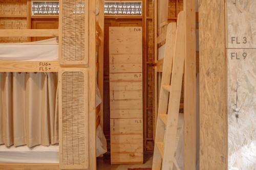 a room filled with wooden shelves with wooden beams at Society House Luxury Hostel in Pai