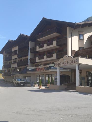 a parking lot in front of a hotel at Hotel Andreas Hofer in Sankt Leonhard im Pitztal