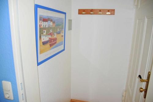a hallway with a painting on the wall at Appartementhaus Sellin in Ostseebad Sellin