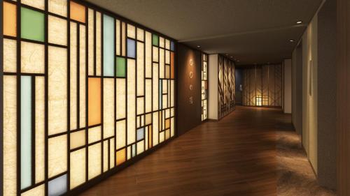 a wall of stained glass windows in a hallway at Dormy Inn Ikebukuro - Natural Hot Spring in Tokyo