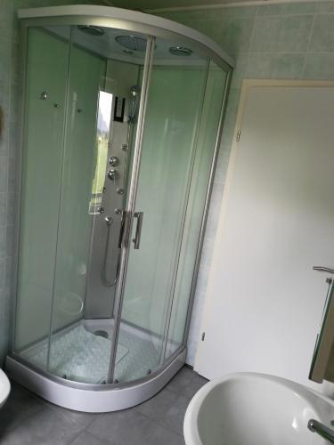 a glass shower in a bathroom with a sink at Tenuta PARAVANO in Povoletto