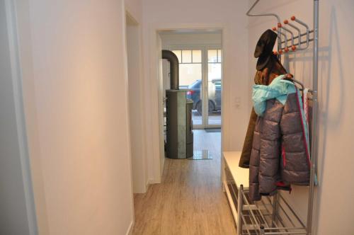 a room with a hallway with a clothes rack at "Ferienwohnungen Appartements - Ferienhaus Müritzglück" in Marienfelde