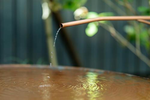 a stream of water coming out of a wooden stick at Shin-Osaka Station Hotel in Osaka