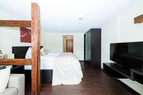 a bedroom with a bunk bed and a television at S'Matt 3 in Lingenau