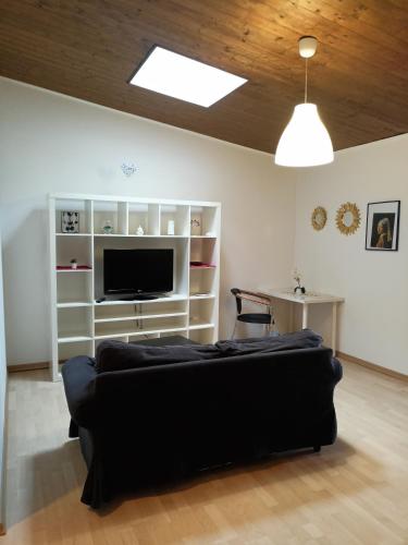 a living room with a couch and a television at Tenuta PARAVANO in Povoletto