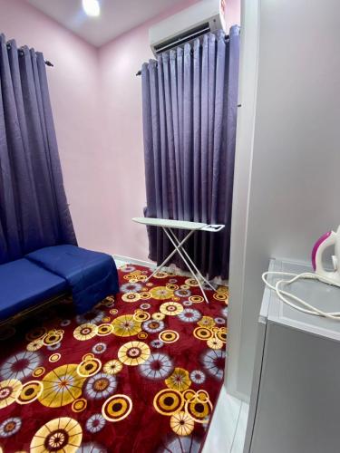 a room with a carpet with flowers on the floor at Sheri homestay in Kuala Nerang