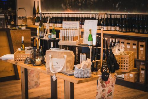 a table with bottles of wine on it in a store at Weinzuhause Hotel-Restaurant-Vinothek in Mommenheim