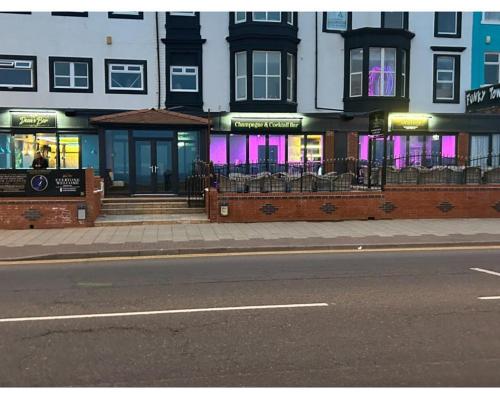 a building on the side of a city street at Woodhouse Hotel Fully refurbished quiet family hotel No stag or hens all will be refused on checkin in Blackpool