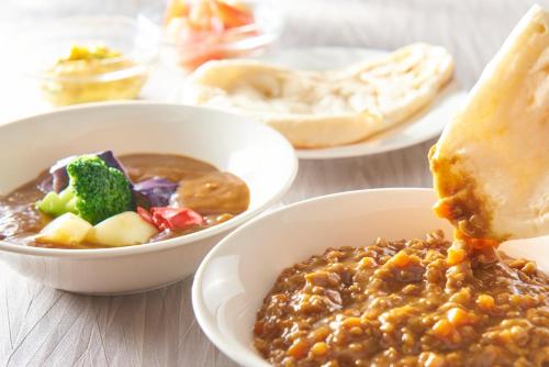 a table topped with bowls of beans and a bowl of food at Kobe Motomachi Tokyu REI Hotel in Kobe