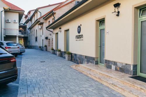 a street with cars parked in front of a building at NOZON Apartments & Wellness in Odorheiu Secuiesc
