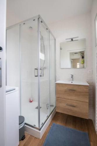 a bathroom with a glass shower and a sink at A bright cocoon for a pleasant stay in Arcachon in Arcachon