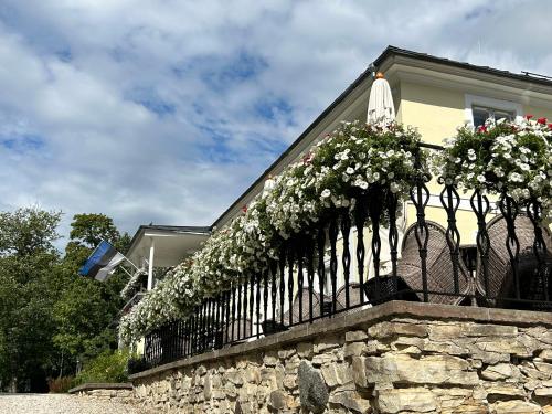 a fence with flowers on it in front of a house at Padise Manor in Padise