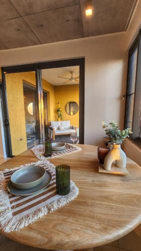a room with a table with plates on it at Penthouse-level Waterfront Apartment in Darwin