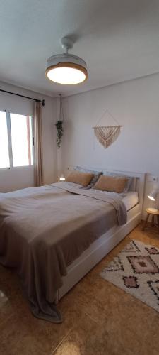 a bedroom with a large bed in a room at Top Floor Apartment-Beach-Pool-La Mata PMT17 in La Mata