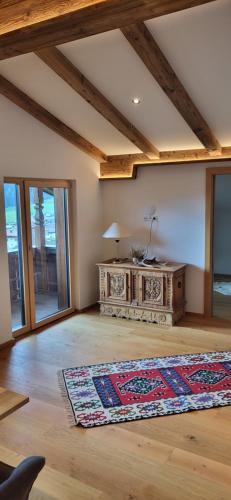a living room with a table and a rug on the floor at Am Waldrand 252 in Neukirchen am Großvenediger