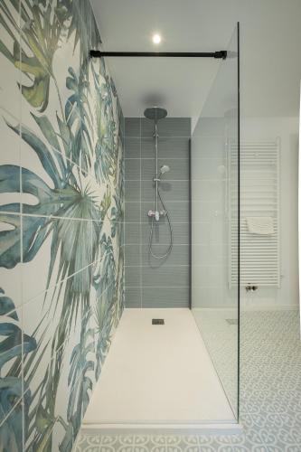 a bathroom with a shower with a glass door at Ferme Sarthou in Lucq-de-Béarn