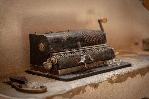 an old sewing machine sitting on top of a counter at Ferme Sarthou in Lucq-de-Béarn
