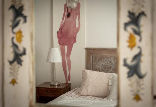 a picture of a bedroom with a dress hanging on the wall at Ferme Sarthou in Lucq-de-Béarn