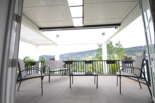 a balcony with chairs and a view of the mountains at The Grove in Kandy