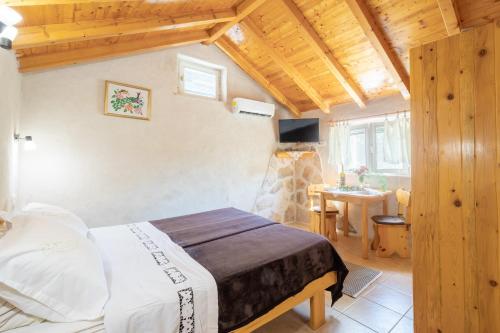 a bedroom with a bed and a table in a room at Stone House Harmony in Korčula