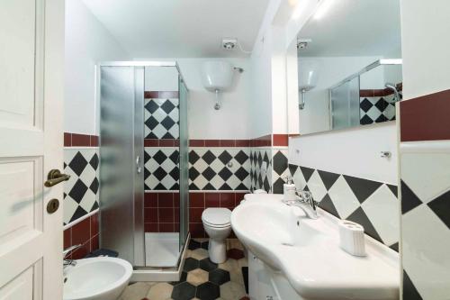 a bathroom with a toilet and a sink and a shower at Vintage Cavour Apartment in Sassari