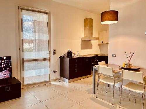 a kitchen with a table and chairs in a room at Residence Del Lago in Desenzano del Garda
