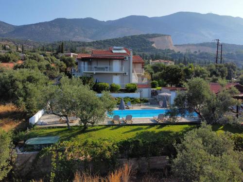 a villa with a swimming pool and mountains in the background at Manolia Studios in Trapezaki