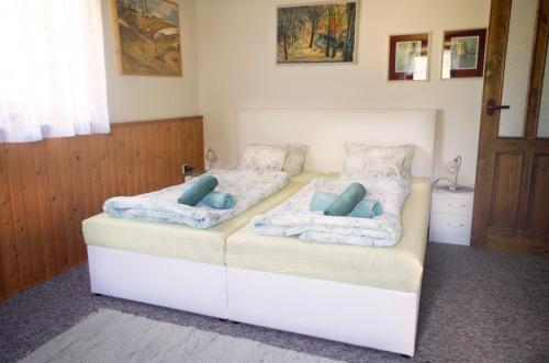 a bed with two pillows on top of it at Pension Sport Ostružná in Ostružná
