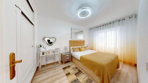 a small bedroom with a bed and a mirror at Pedro Lorca in Torrevieja