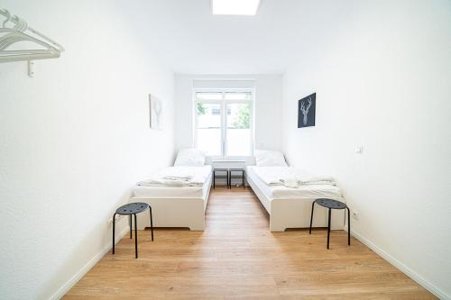 En eller flere senge i et værelse på DQ01 - Monteurwohnung - WLAN - 5 Personen