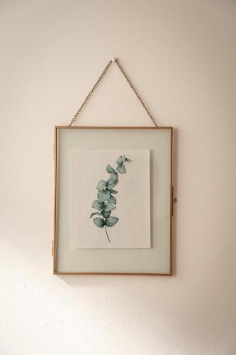 a framed picture of a plant on a wall at Ferme Sarthou in Lucq-de-Béarn