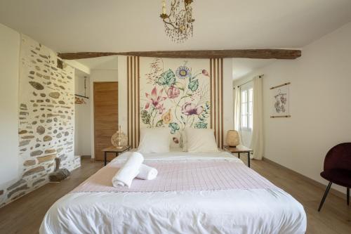 a bedroom with a large bed with towels on it at Ferme Sarthou in Lucq-de-Béarn