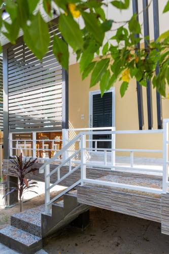 a white railing in front of a building at Apple Villas in Haad Chao Phao