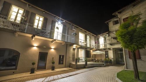 an empty street at night with buildings with lights at Casa Andrea in La Morra