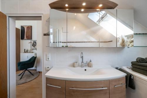 a bathroom with a sink and a mirror at Vitaloase Bad Griesbach im Rottal/70qm/Auszeit/Parkplatz in Bad Griesbach