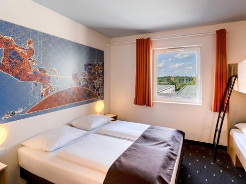 Postel nebo postele na pokoji v ubytování B&B HOTEL Magdeburg-City