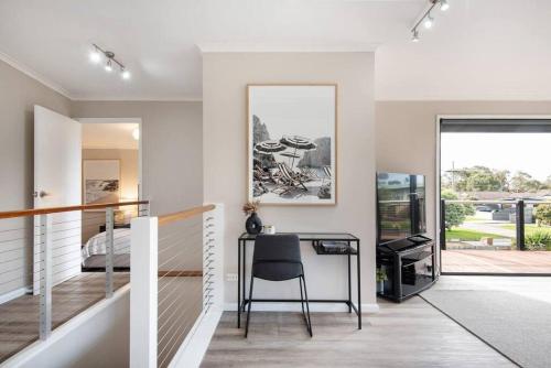 a home office with a desk and a bedroom at Dreamy Dromana Family Getaway - with Jacuzzi in Dromana