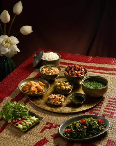 a table with bowls of food on a table at Solaria Hanoi Hotel in Hanoi