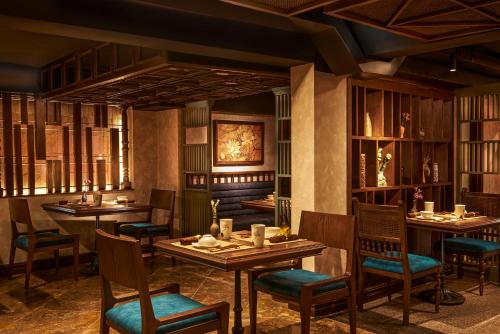 a restaurant with tables and chairs in a room at Solaria Hanoi Hotel in Hanoi