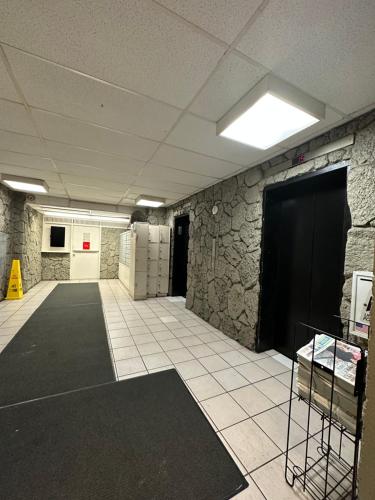 a large room with a stone wall and a large door at WELLCOME TO LOVELY CONDO 2 BEDS 2 BATHS FREE PARKING IN WAIKIKI BEACH in Honolulu