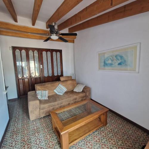 a living room with a couch and a ceiling fan at Arsenal Azul in Villajoyosa
