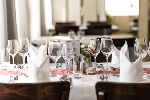 a table with wine glasses and napkins on it at Kaiser von Österreich, Historik- und Thermalhotel in Bad Radkersburg