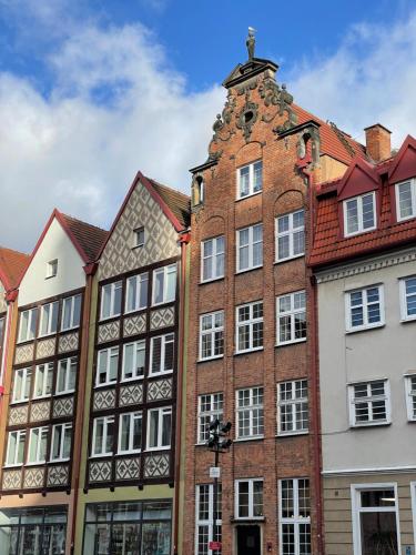 a large brick building with a tower at Art space at Old Town in Gdańsk