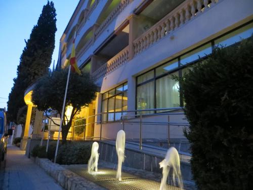 two statues of swans in front of a building at Hotel Baviera in Cala Ratjada