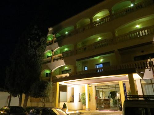 a building with green lights on top of it at Hotel Baviera in Cala Ratjada