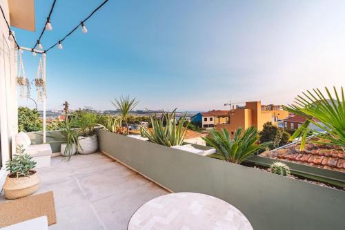 a balcony with chairs and plants on a building at Casa Senhorinha in Porto