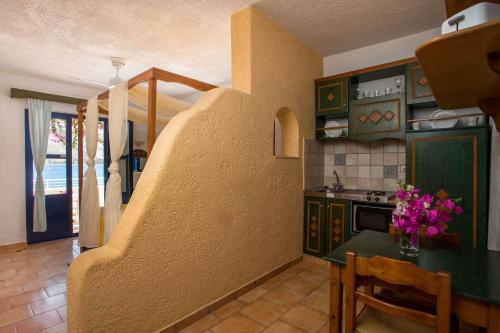 a kitchen with a table with flowers on it at ILIDI Rock in Livadia