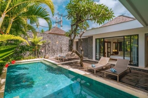 a villa with a swimming pool and a house at Villa Anahata: Modern 2BR Villa w/ Pool in Seminyak ! in Seminyak