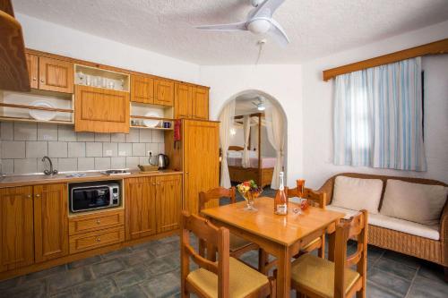 a kitchen with a wooden table and a dining room at ILIDI Rock in Livadia