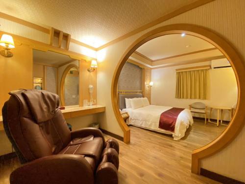 a hotel room with a bed and a mirror at I Live Motel in Kaohsiung
